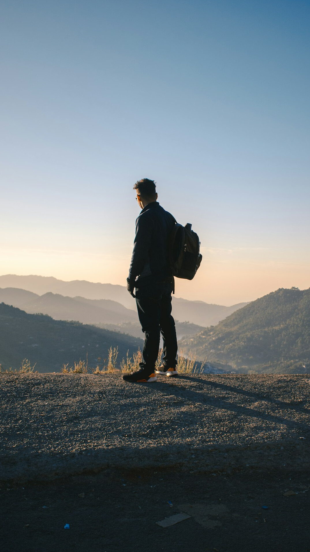 person standing on mountain at sunrise